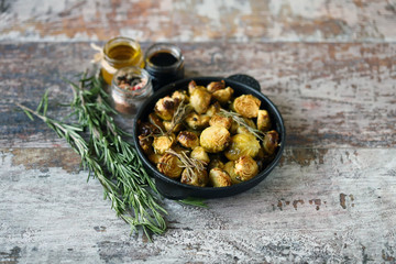 Baked Brussels sprouts with rosemary and spices. Frying pan with baked brussels sprouts.