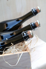 sparkling wine bottles in a wooden box