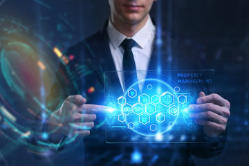 Business, Technology, Internet and network concept. Young businessman working on a virtual screen of the future and sees the inscription: Property management