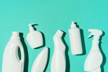 Pattern of white plastic bottles, containers of chemical cleaning products on blue background. Top view. Flat lay. Stop plastic, recycling, separate collection of garbage concept