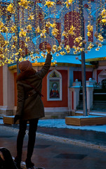 New Year decorations on Nikolskaya street in Moscow, Russia, Young woman touching New Year's decoration