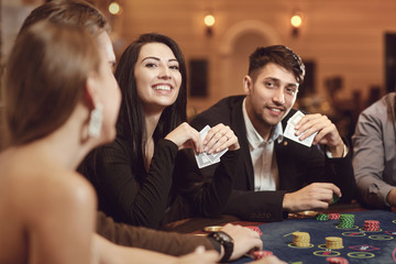 Friends gamble poker roulette in a casino