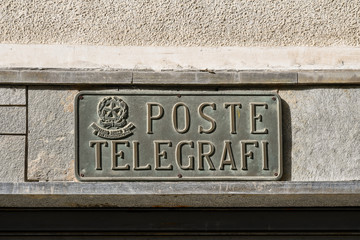 Close-up of an old metal plate sign with the written 