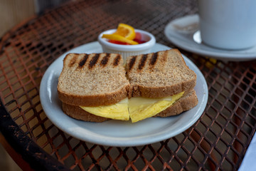 Egg sandwich and fruit with cofffee in restaurant