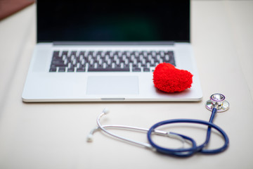 red heart with laptop and stethoscope