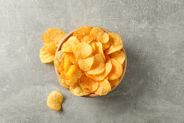 Potato chips. Beer snacks on grey background, space for text. Top view