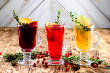 three glasses mulled wine on a rustic wooden table copy space background