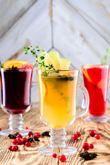 three glasses mulled wine on a rustic wooden table copy space background