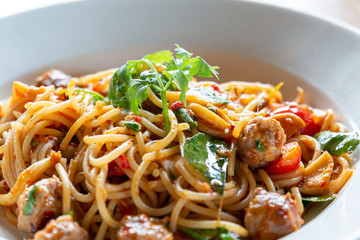 Spicy Spaghetti pasta with meatballs and tomato sauce. Spaghetti and Meatballs. Delicious Italian pasta with tomato and chili sauce. Hot Spicy spaghetti with meatballs and chili herbs.