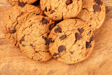 Gluten-free chocolate chip cookies close-up on a rustic wooden background, top-down shot