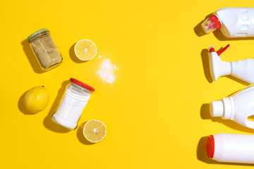 Flat lay composition with eco-friendly natural cleaners. Baking soda, salt, lemon and mustard powder on yellow background. Top view. Copy space. Flat lay. Homemade green cleaning.