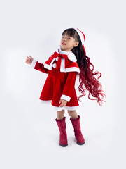 Asian girl is wearing a Santa costume to celebrate Christmas. White background