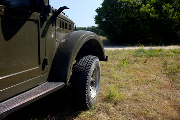 Retro style soviet off-road cars during a trip in forest