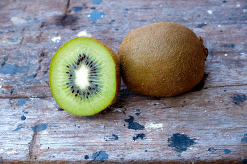 Ripe fresh kiwi fruits and half sliced