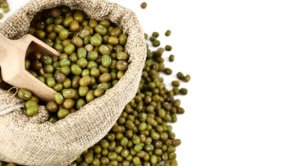 raw mung bean or green bean in sackcloth, isolated on white background