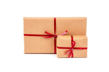 Gift Boxes in Craft Wrapping Paper with Red Ribbons isolated
