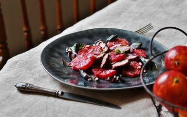 salad with red Sicilian orange (blood orange), duck breast, beet top (chard), sunflower seeds, red onion. gourmet recipe, winter salad