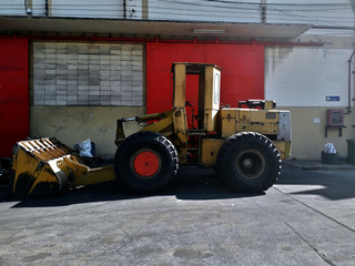 Big yellow car loader in the warehouse.