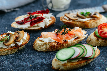 Bruschetta with mushrooms, cucumbers, avocado, radish, salmon and egg