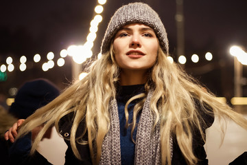 beautiful girl in winter hat near the Christmas tree, winter holidays, holiday and walks photo...
