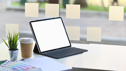 Fototapeta premium Mockup tablet on workspace with coffee, colour book.