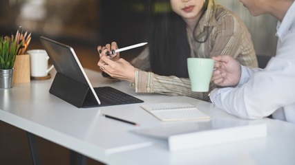 Cropped shot Young professional designer team discussing the idea concepts together in modern office room.