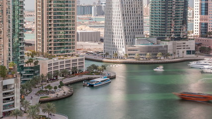 Naklejka premium Aerial view of Dubai Marina residential and office skyscrapers with waterfront timelapse