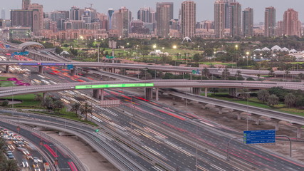 Dubai Golf Course with a cityscape of Gereens and tecom districts at the background aerial day to night timelapse