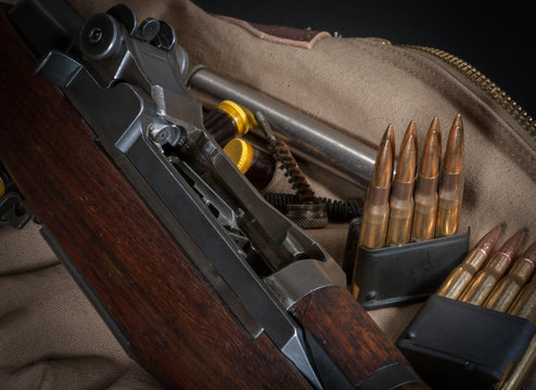 American WWII battle rifle M1 with 30-06 ammunition in en bloc clips with grease pots and nickel oiler tube