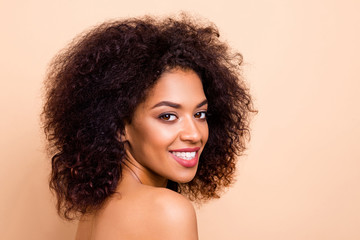 Close up side profile photo beautiful she her dark skin lady fluffy hairstyle hairdo refreshed salon spa procedures aesthetic pure perfect appearance wear nothing isolated pastel beige background