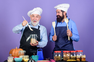 need advice. Halloween pumpkin recipe. mature senior bearded men in kitchen. cereals and seasoning. professional restaurant cook. Chef men cooking. cheerful men prepare food. Healthy food cooking