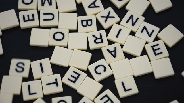 Jumbled letters on a black background. Business concept for joining together, goal setting, scrambled, change.