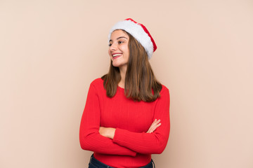 Young girl with christmas hat over isolated background laughing