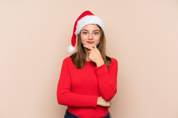 Young girl with christmas hat over isolated background laughing