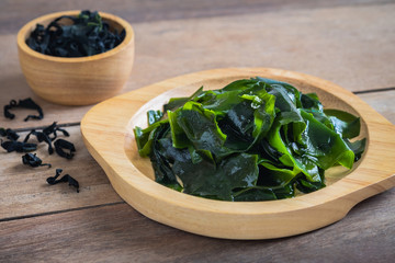 Wakame seaweed on wooden plate