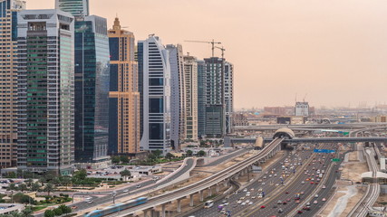 Naklejka na ściany i meble Aerial top view to Sheikh Zayed road near Dubai Marina and JLT day to night timelapse, Dubai.