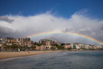 Rainbow over the old town of Villajoyosa with colorful houses, mountains and the sea, Spain