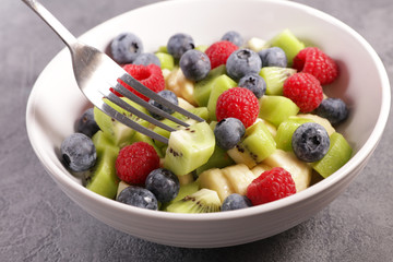 fruit salad in bowl with blueberry, kiwi, raspberry and banana