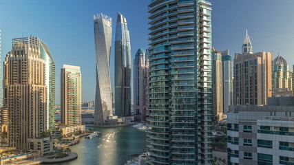 Fototapeta na wymiar Aerial view of Dubai Marina residential and office skyscrapers with waterfront timelapse