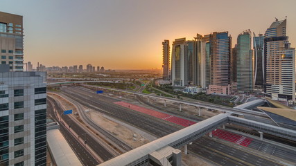 Fototapeta premium Aerial top view to Sheikh Zayed road during sunrise near Dubai Marina and JLT timelapse, Dubai.