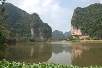 Panoramic view of karst formations and rice paddy fields in Tam Coc, a part of Trang An Complex , was  declared a UNESCO World Heritage Natural and Cultural Monument.Ninh Binh province, Vietnam