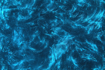 Abstract elegant, detailed blue glitter particles flow with shallow depth of field underwater....