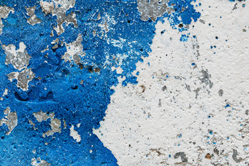 Grungy wall with peeling blue paint