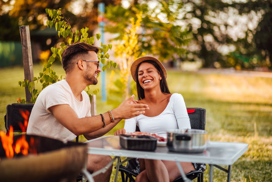 Young couple relaxing in backyard.