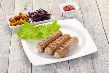 Grilled sausages served mushrooms and cabbage