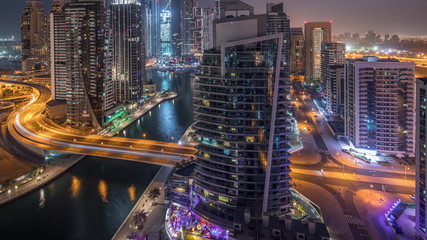 Fototapeta na wymiar Aerial view of Dubai Marina residential and office skyscrapers with waterfront night to day timelapse