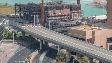 Aerial view to Dubai marina skyscrapers with construction site and Palm Jumeirah Island on background timelapse.