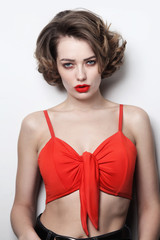 Fototapeta premium Young beautiful slim sexy woman with curly hair and red lips