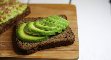Avocado toast on the rye bread. Healthy food concept.