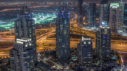 Dubai Marina skyscrapers and jumeirah lake towers view from the top aerial night timelapse in the United Arab Emirates.